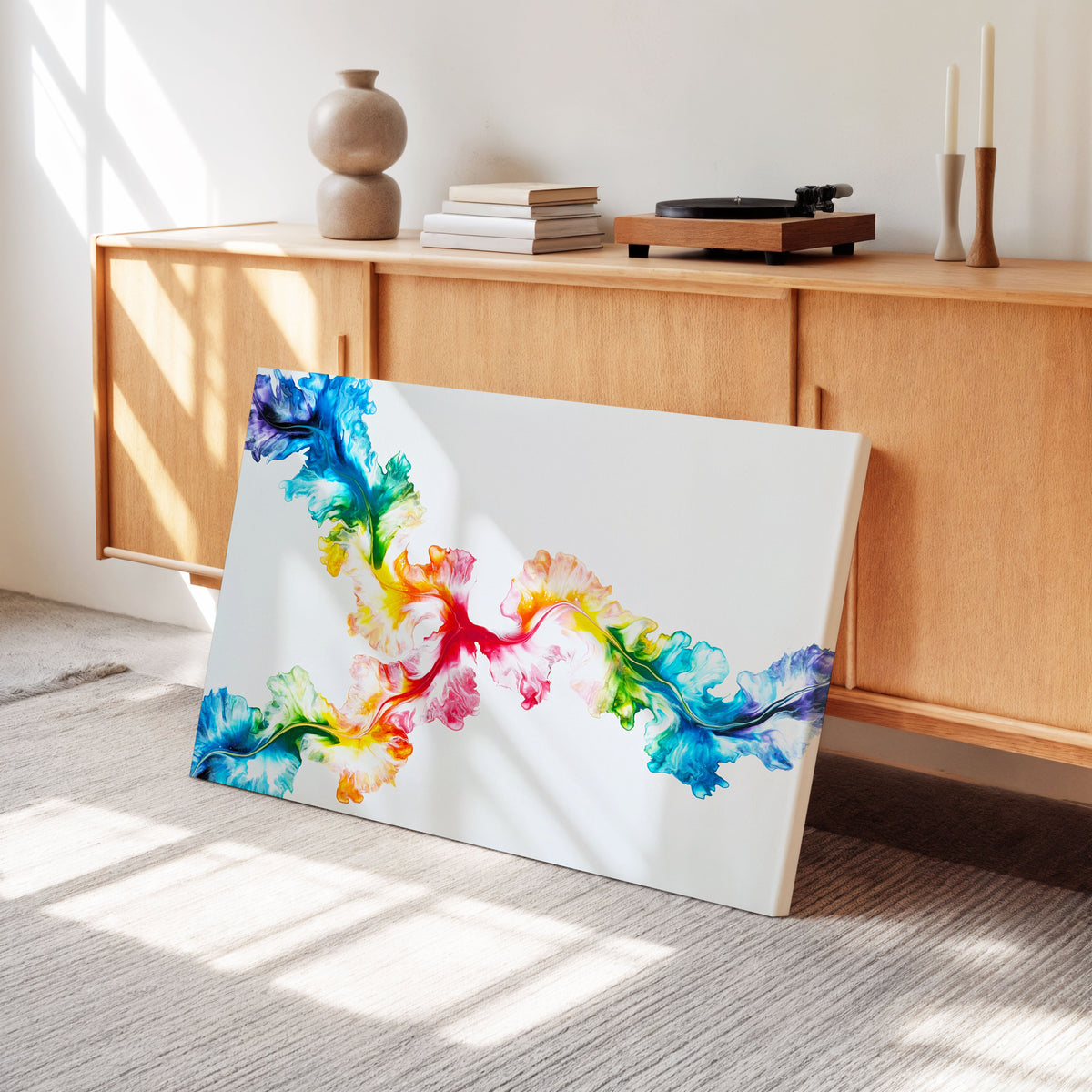 Angle view of Never Dim Your Light, an original fluid painting by Abby May, shown in a room leaning against a wood console, with the canvas edge visible.