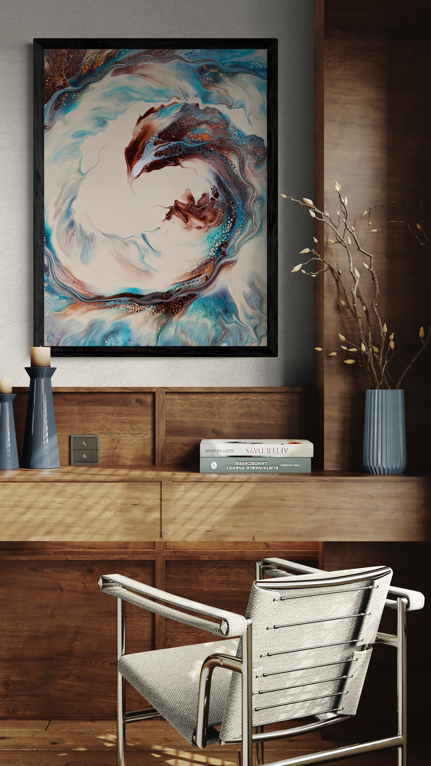 The “Phoenix” collector’s edition print is mounted above a wooden desk with ceramic vases and books. The swirling abstract design in copper, turquoise, and tan evokes motion and rebirth in the warm, stylish workspace.