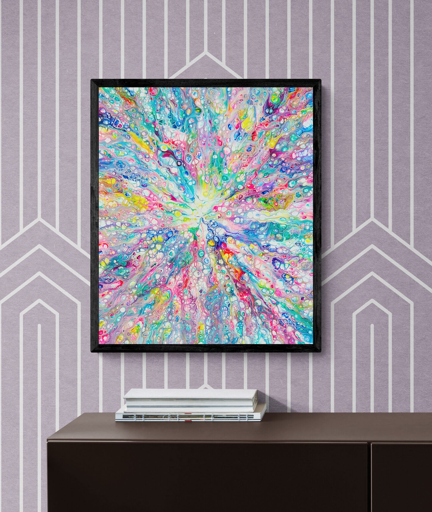 Rainbow Dragon fluid art wall print in vivid rainbow hues, framed in black and styled on a purple geometric patterned wall.