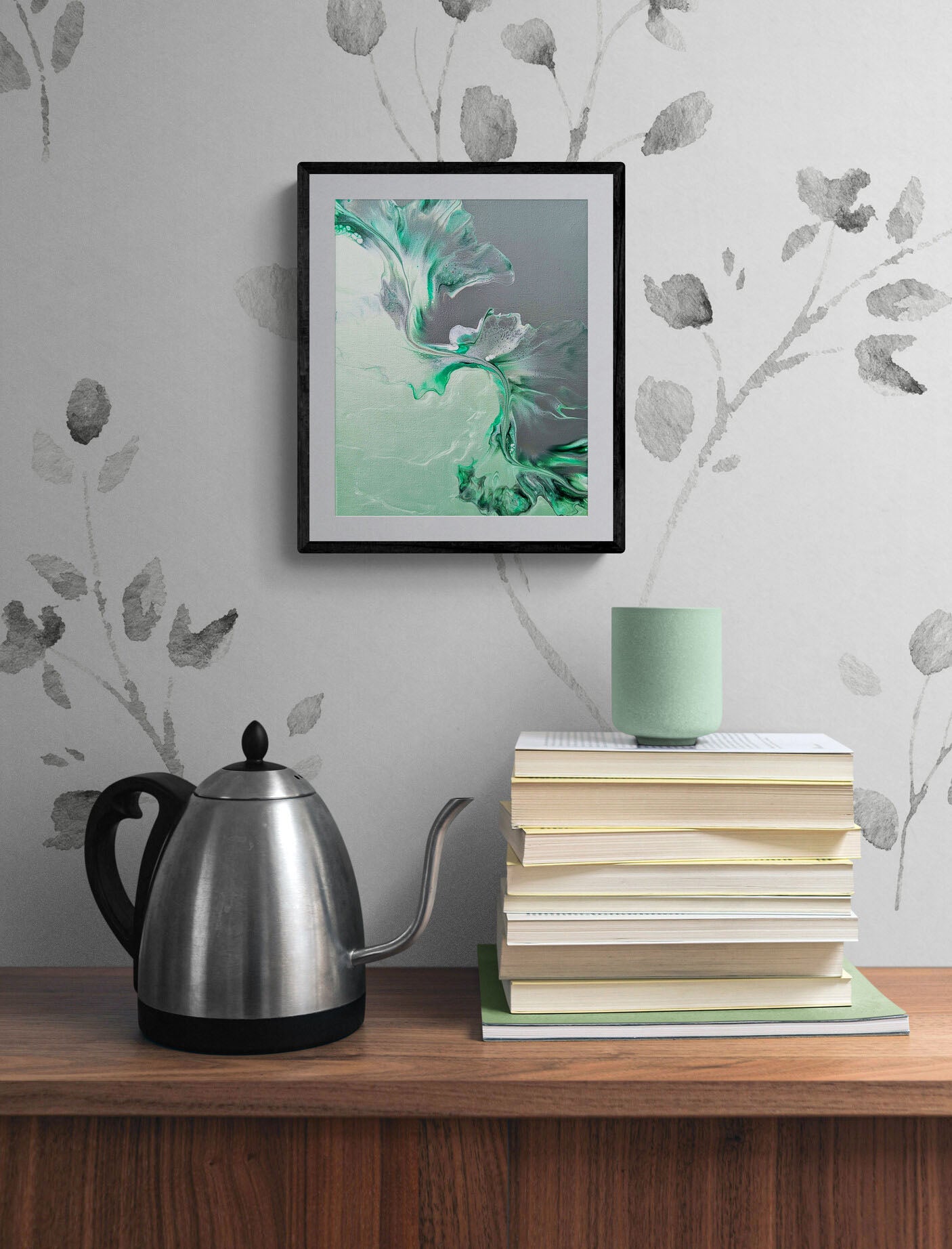 Sea Glass – teal and gray abstract fluid art print, framed wall art displayed above stacked books and a modern kettle.