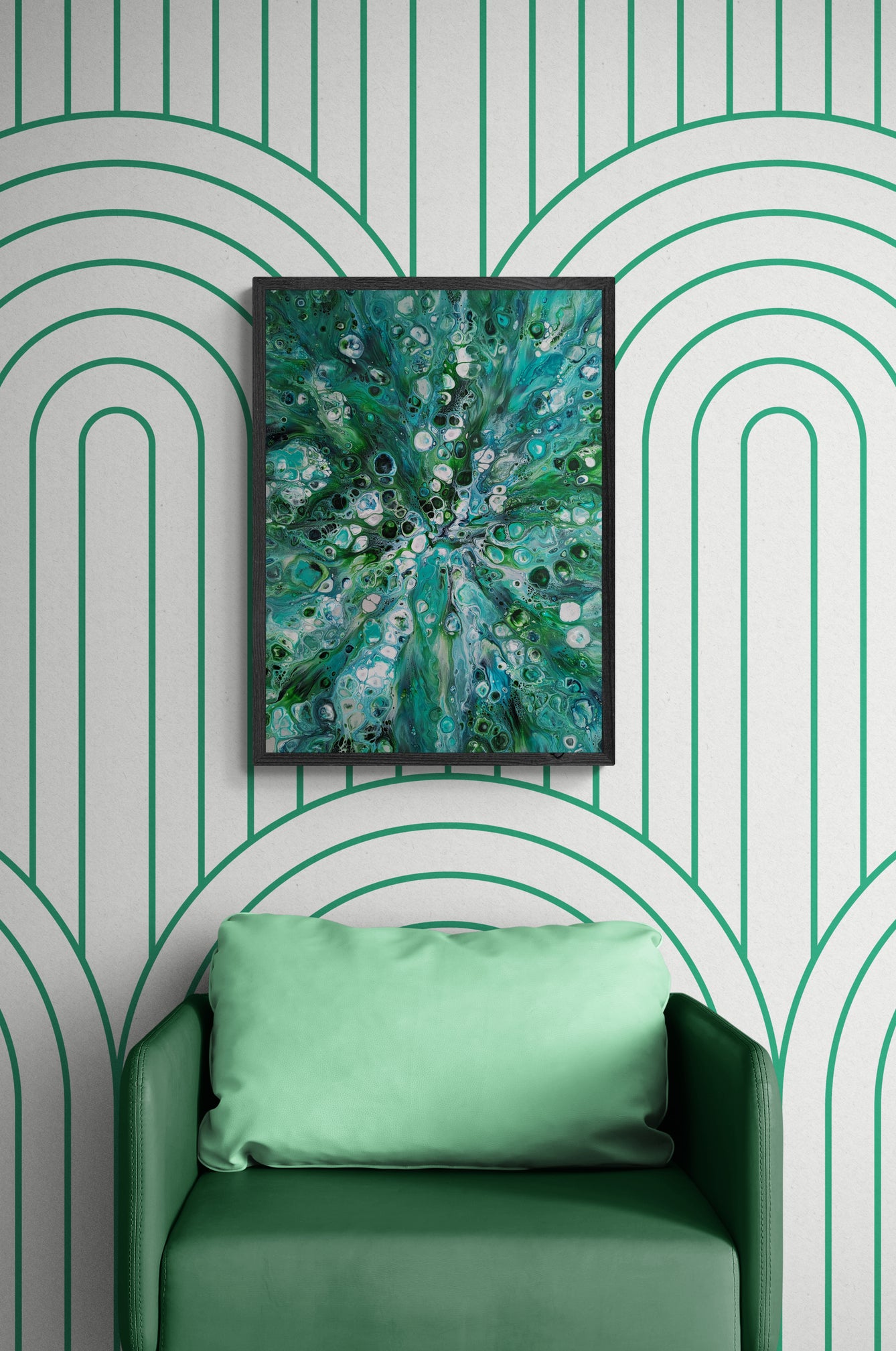 Sea Maiden fluid art painting framed in black, styled above a soft green chair against a white and green arched wall pattern.