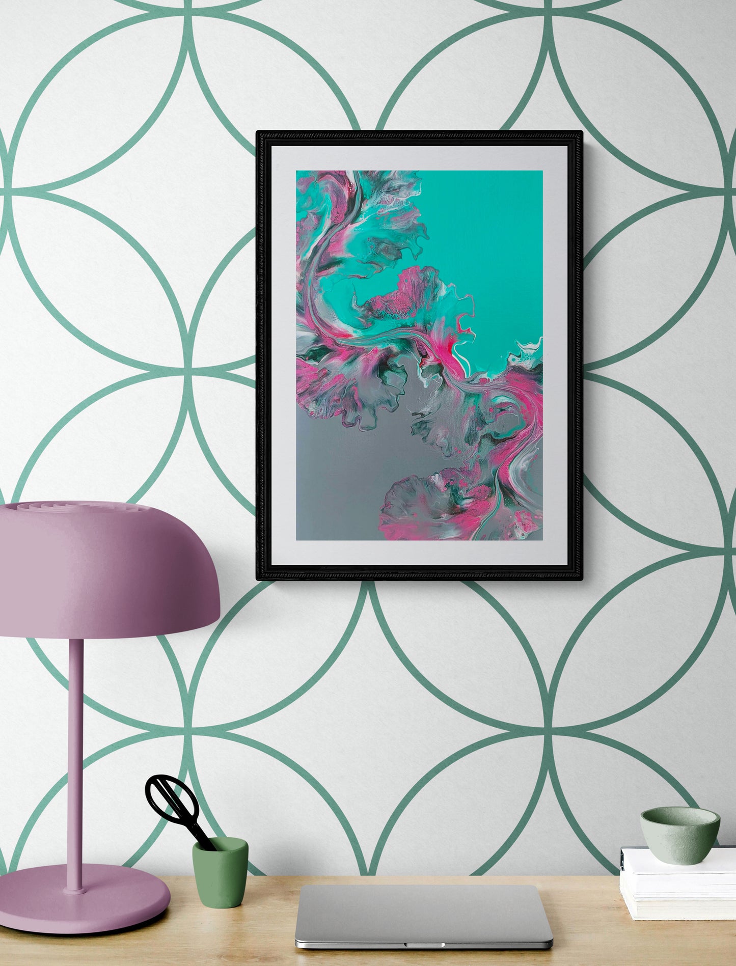 Slow Ascent – abstract fluid art print in teal, pink, and silver, framed wall art above a modern desk with mauve lamp and laptop.