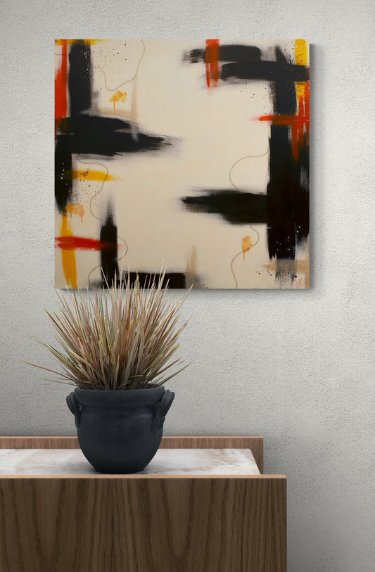 A large square contemporary abstract canvas print with heavy brown strokes and warm orange highlights, hung on a light grey wall behind a dark potted plant on a marble and wood console.
