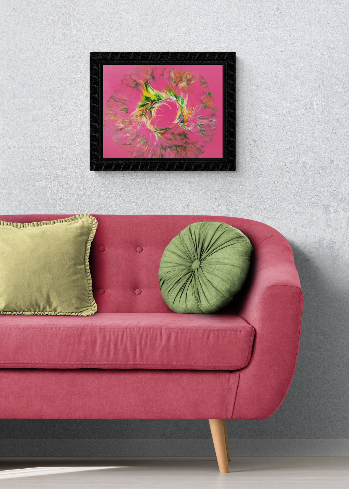 Sprout Out" abstract acrylic fluid art painting in vivid pink, green, and yellow tones, framed in black and hung above a blush pink sofa with green pillows, styled against a soft gray wall.