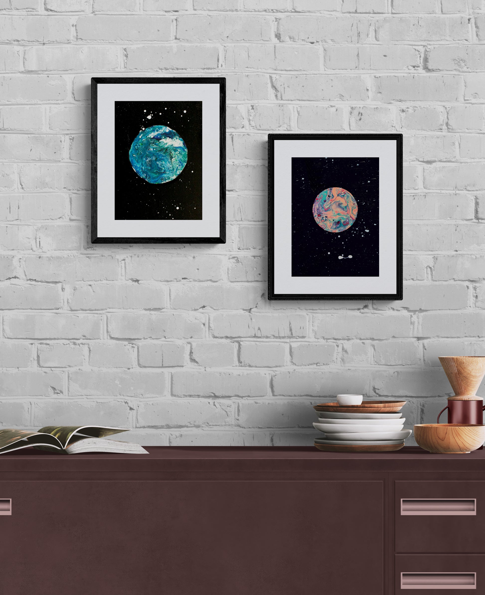 Blue Moon and Strawberry Moon framed prints side by side on a white painted brick wall; styled with stacked dishes and wooden kitchen decor.