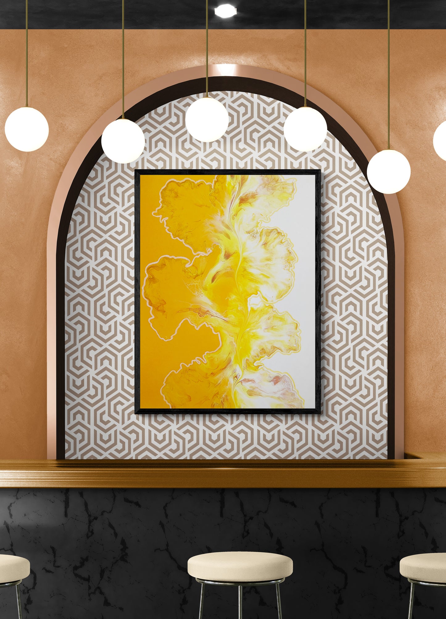 Yellow and white abstract fluid art print framed in black, displayed within an arched alcove with geometric wallpaper and pendant lighting above a modern bar.