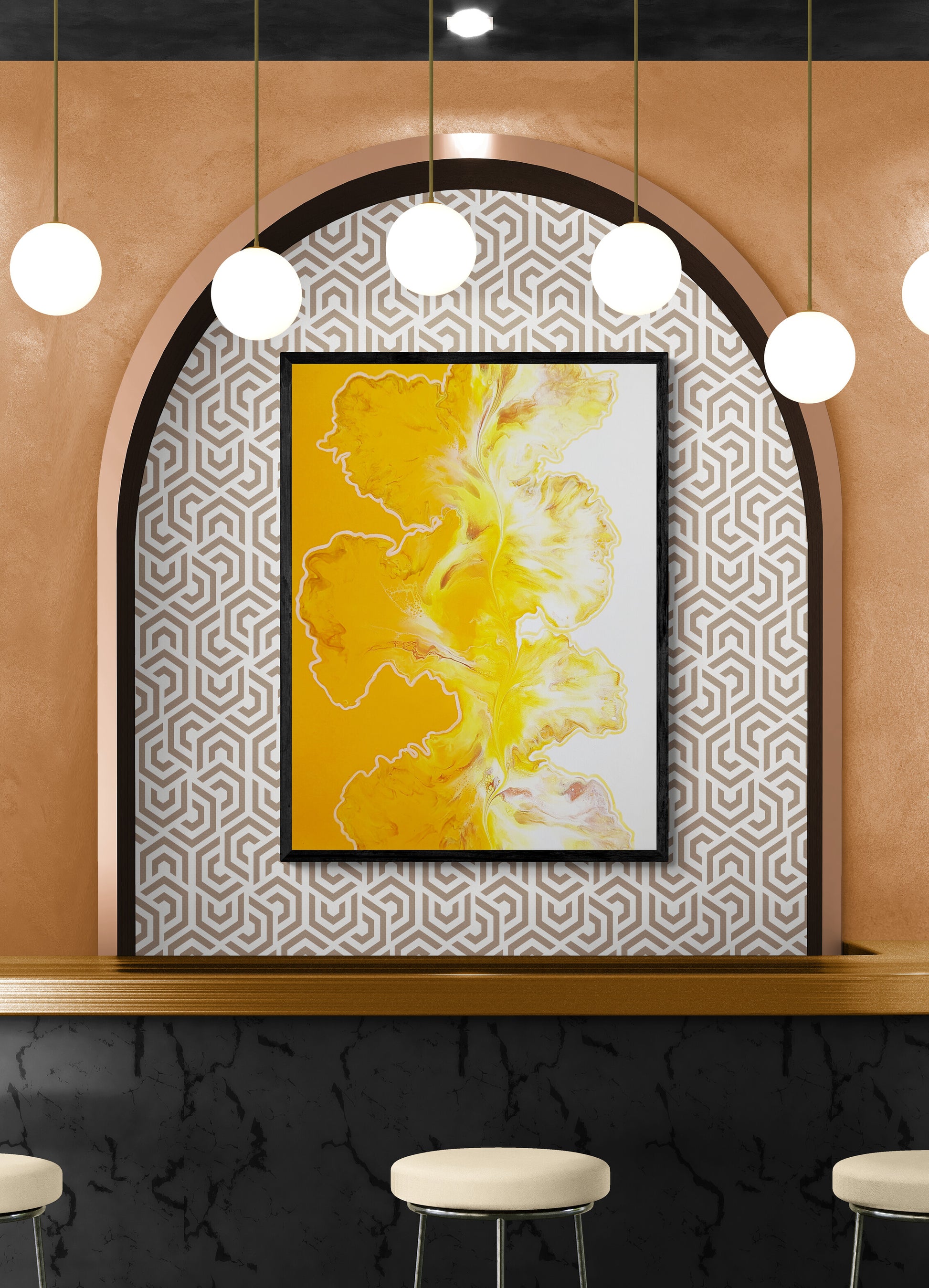 Yellow and white abstract fluid art print framed in black, displayed within an arched alcove with geometric wallpaper and pendant lighting above a modern bar.