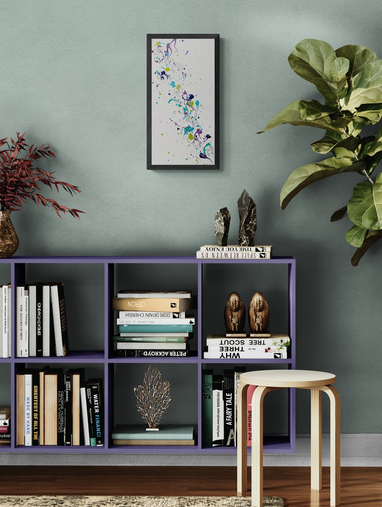 A vertical abstract painting with soft swirls of purple, teal, navy, green, and silver is framed and hung on a light mint green wall. Below it sits a purple cubed bookshelf filled with books, sculptures, and decorative objects. Surrounding the setup are two leafy indoor plants and a light wood stool, creating a lively yet calm reading nook.