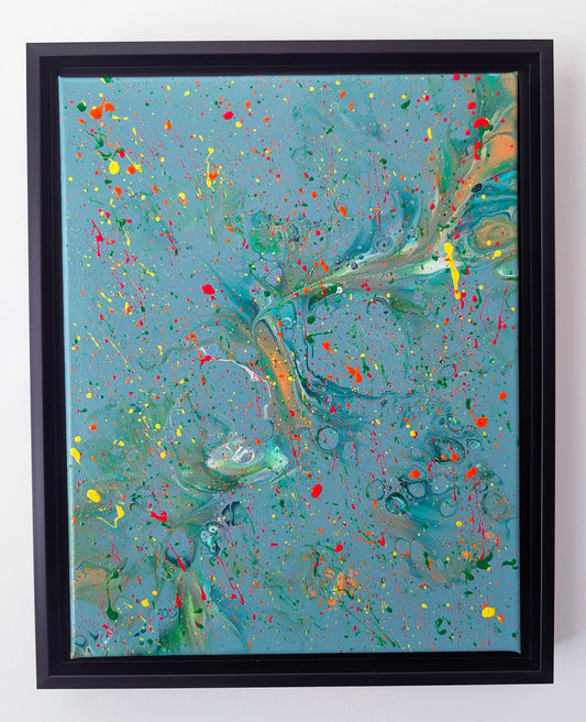 Framed abstract acrylic fluid art painting with a teal blue background. The surface is covered in vibrant splatters of neon red, yellow, orange, and green, with swirling marbled sections adding depth and movement throughout the piece.