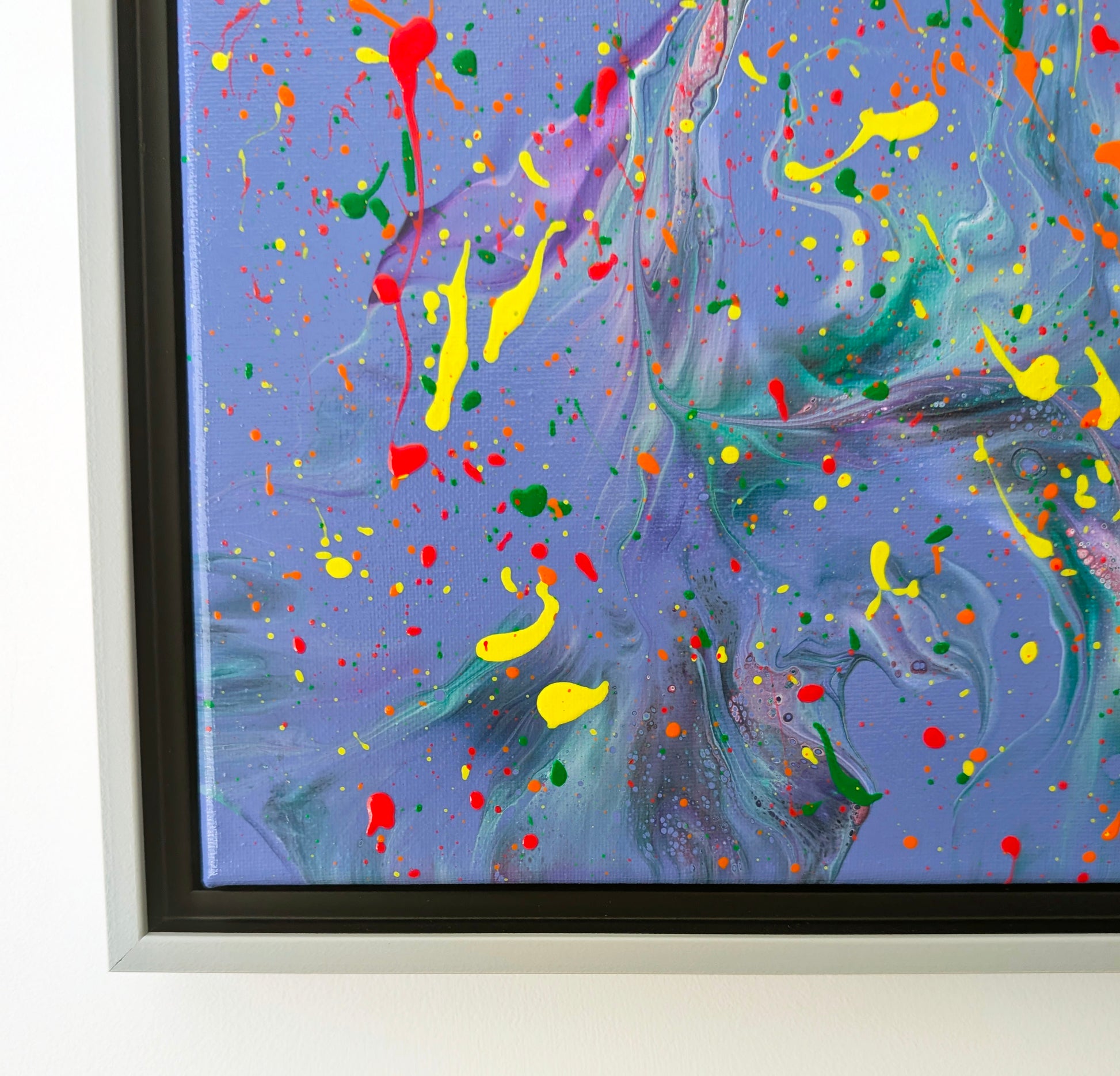 Close-up of the bottom left area of the painting, highlighting soft marbled effects in purple and teal with vibrant yellow and red splatters layered on top. Small bubbles and lacing add textural interest.