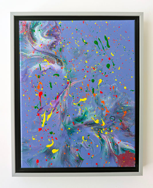 Framed acrylic fluid art painting with a lavender-purple background and flowing marbled textures in green, teal, and hints of pink. Bold neon splatters of yellow, red, orange, and green are scattered across the canvas, creating energetic contrast.