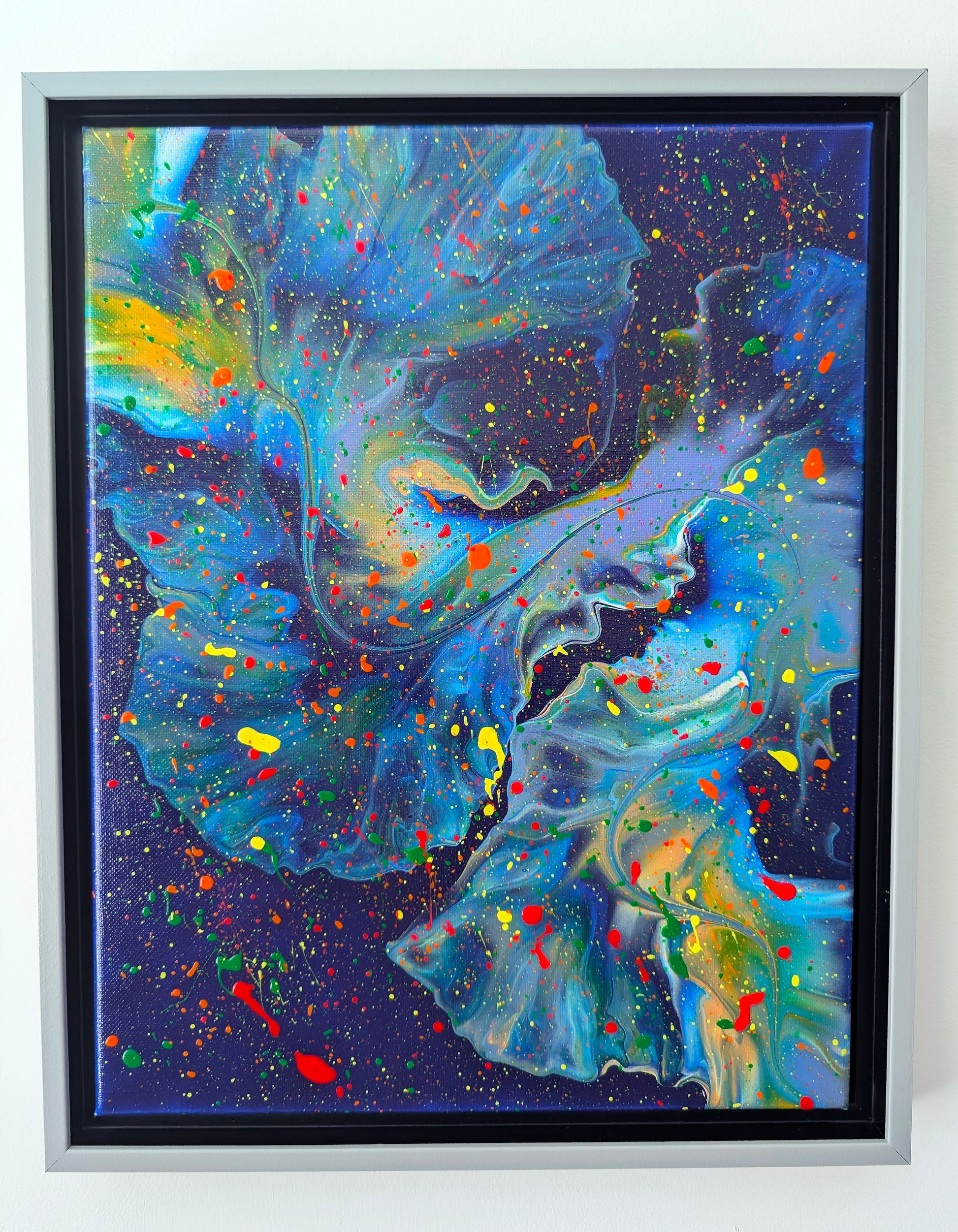Framed original fluid painting with a dark blue background, swirling teal and purple forms, and expressive splashes of red, yellow, orange, and green.