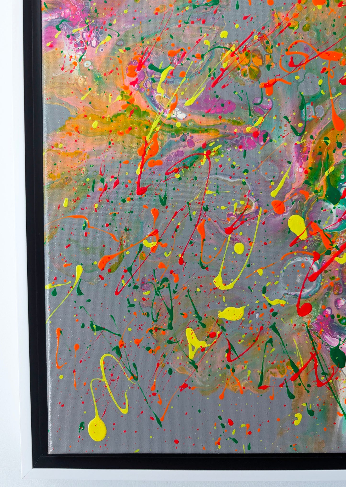 Close-up of the lower left corner of a fluid acrylic painting, focusing on intricate cell-like textures, layered paint swirls, and vivid drips in green, pink, and yellow.