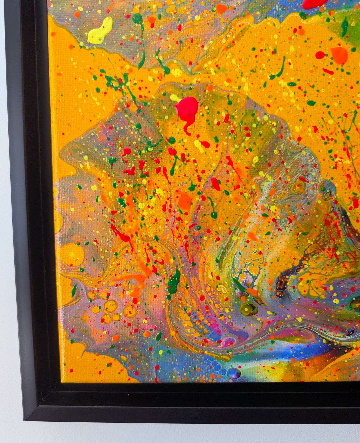 Close-up of the lower left corner of the painting, showcasing bold orange and pink swirls blended with neon splatters in green, yellow, and red. Delicate lacing and bubble-like textures appear throughout the marbled areas.