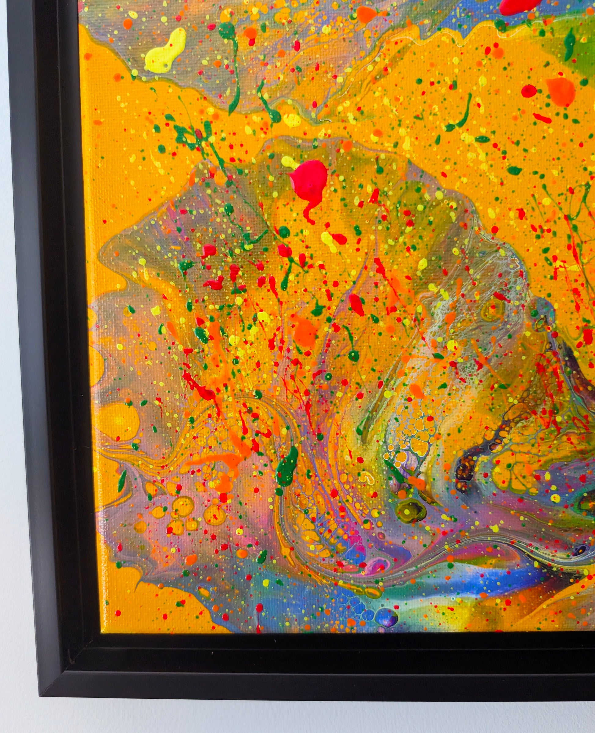 Close-up of the lower left corner of the painting, showcasing bold orange and pink swirls blended with neon splatters in green, yellow, and red. Delicate lacing and bubble-like textures appear throughout the marbled areas.