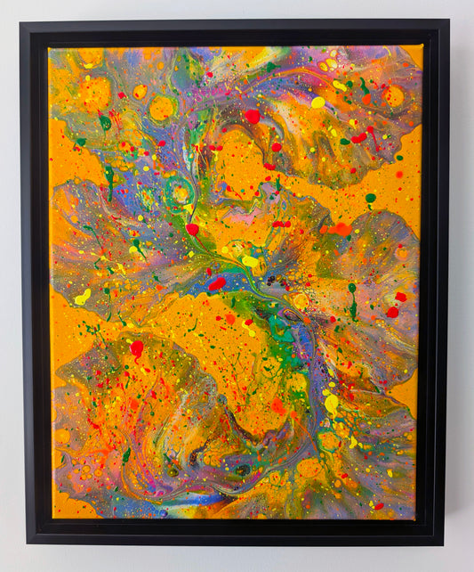 Framed acrylic fluid art painting with a bold, bright yellow-orange background. Layers of swirling purples, greens, and pinks flow through the piece, with neon splatters of red, yellow, and green creating an energetic, chaotic overlay.