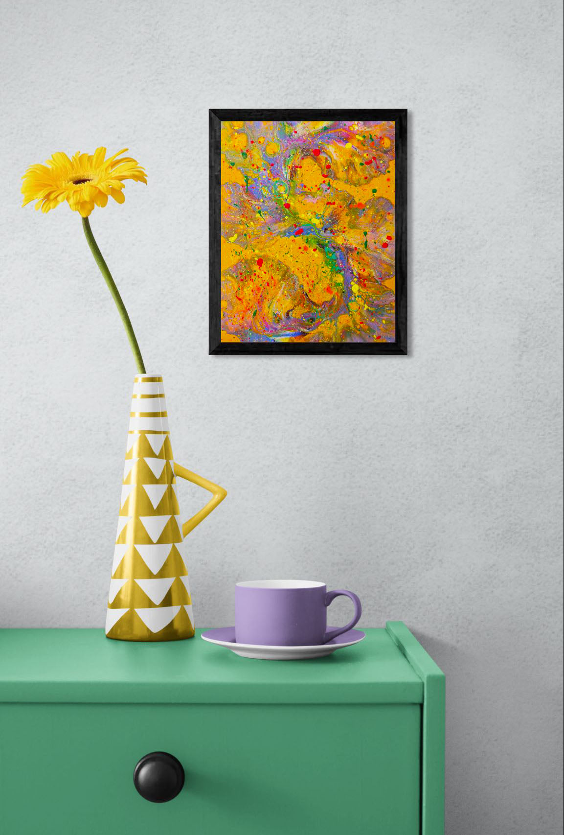 Mockup of the painting hung on a light gray wall above a green table with a geometric yellow vase and a lavender cup and saucer. The bold colors of the artwork create a vibrant, playful vibe in the room.