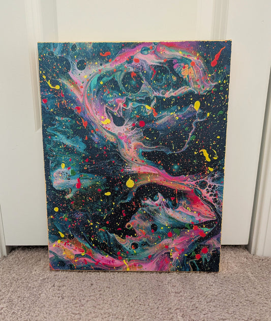 Front view of an abstract dark fluid art canvas with swirling teal, pink, purple, and yellow tones, layered with colorful paint splatters. The canvas edges are finished with gold leaf.