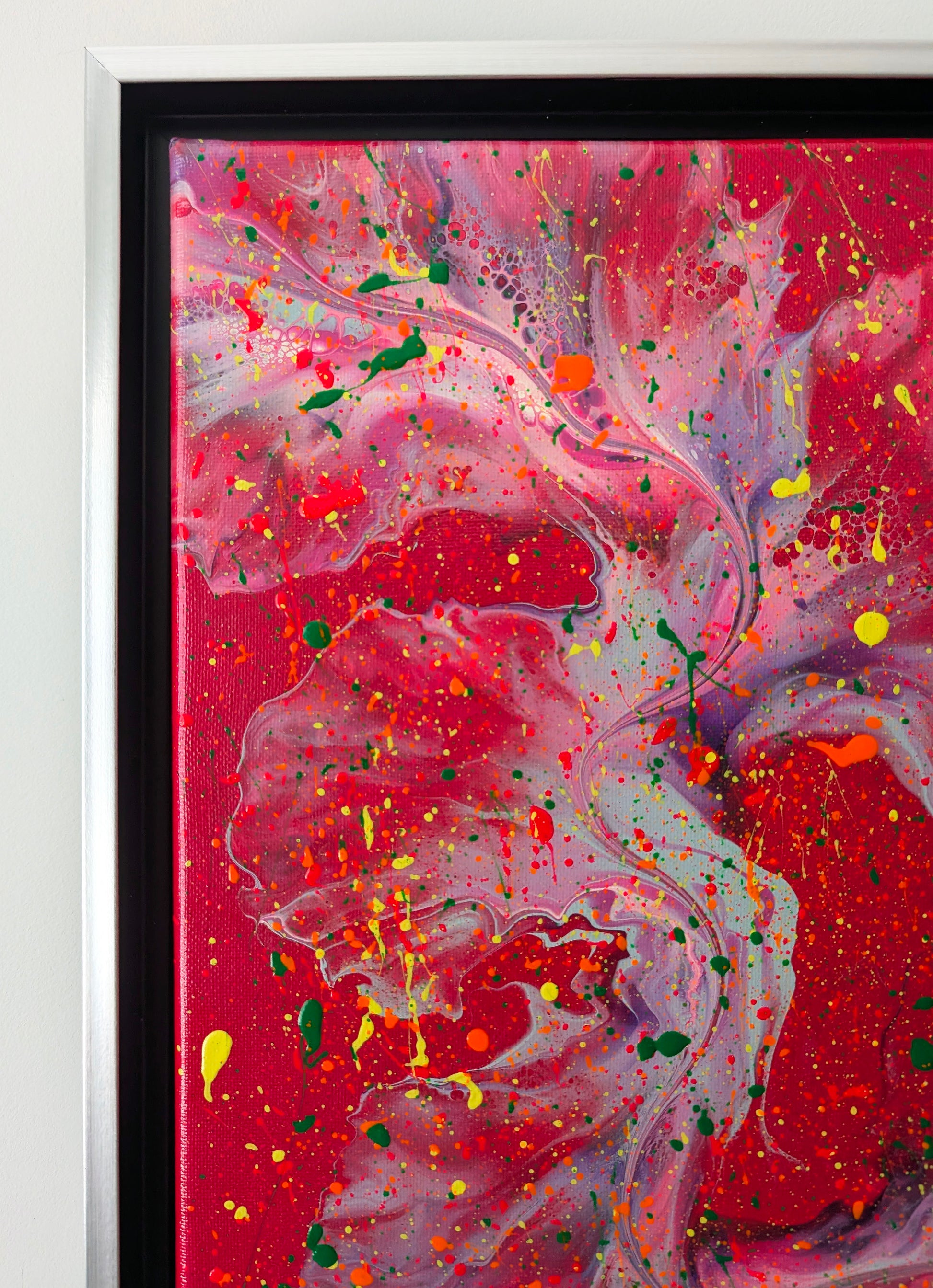 Detail view of the upper left corner of the painting, showcasing delicate lavender and purple cells layered over a rich red base, with vivid splashes of yellow, green, and orange paint