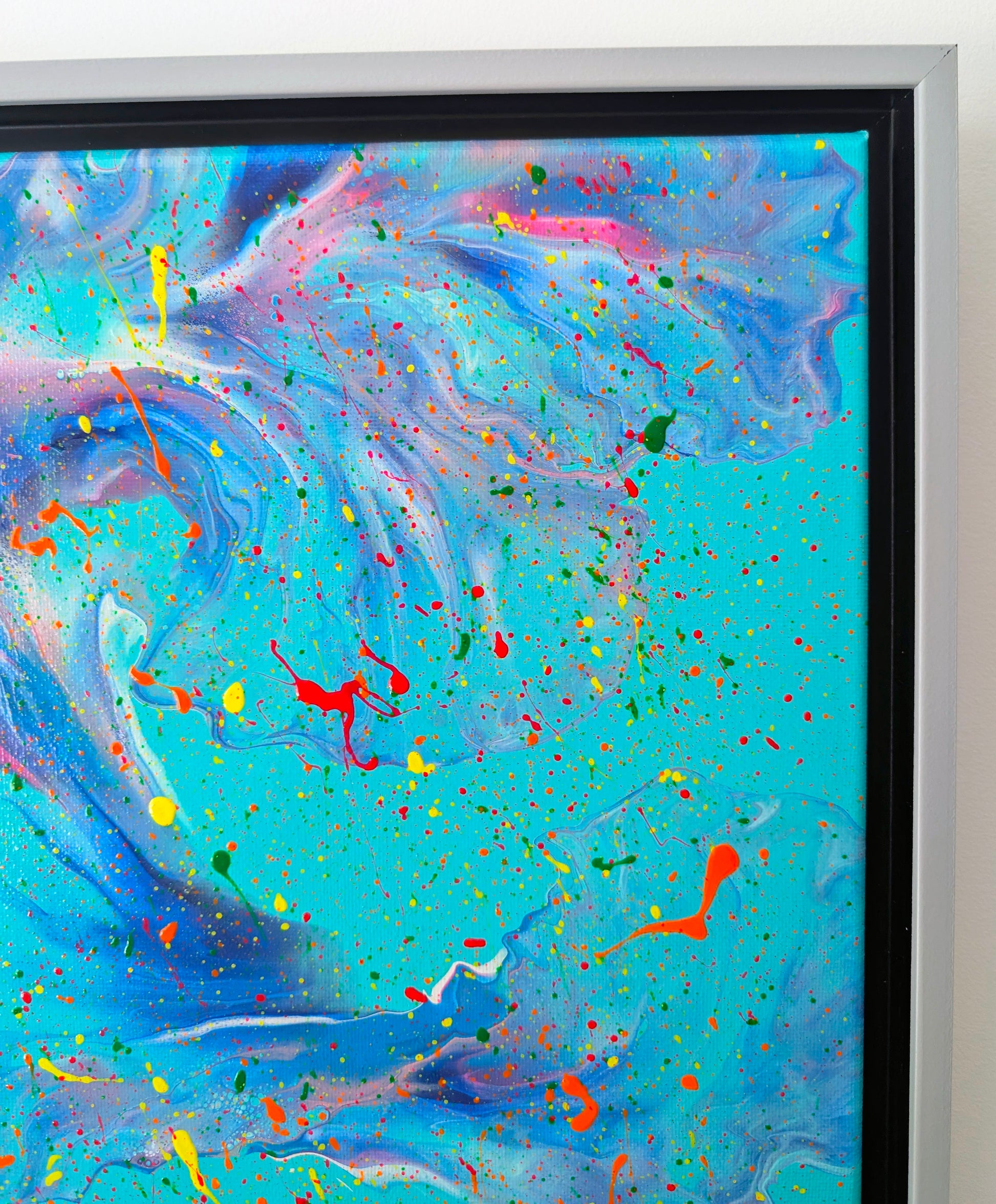 Close-up of the top right section focusing on delicate shifts from blue to pink and purple, with fine and bold paint splatters overlaying the fluid textures.
